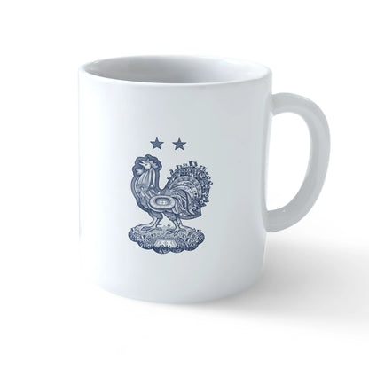 A white ceramic mug shown from multiple angles, featuring a stylized navy blue rooster and 'ALLEZ LES BLEUS!' text with two stars on one side, and a highly detailed heritage rooster crest containing French landmarks on the other - sports drinkware by Stick-On Limited.
