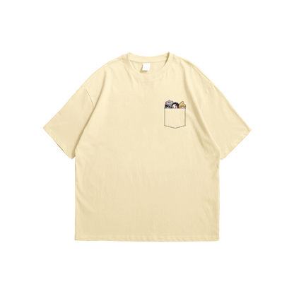 Demon Slayer Pocket Oversized T-Shirt – beige chibi anime design with Tanjiro, Inosuke, and Zenitsu in pocket, Stick-On Apparel Collection
