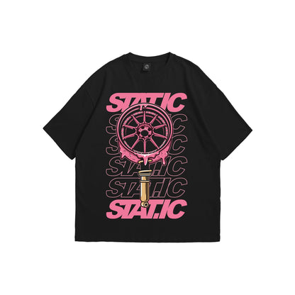 Front and back view of a black oversized t-shirt featuring a pink melting car wheel and coilover graphic with repeating STATIC text on the chest - automotive streetwear apparel by Stick-On Limited.