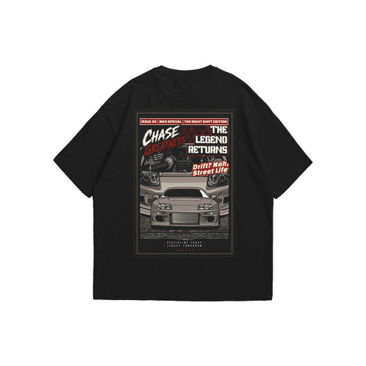 A black oversized t-shirt shown from the front and back. The front features a minimalist white 'Supra' script logo in the center of the chest. The back displays a large, detailed magazine-style graphic of a grey Toyota Supra MK4 and its engine bay, framed by the bold text 'CHASE GREATNESS', 'THE LEGEND RETURNS', and 'Drift? Nah, Street Life'.