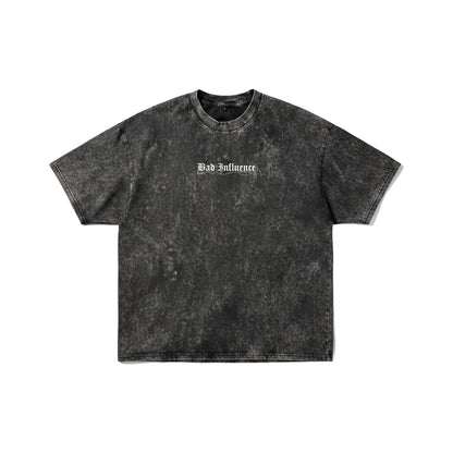 Dark grey acid wash t-shirt with "Bad Influence" gothic text on front and large white skeleton spine wings on back - grunge streetwear by Stick-On Limited.